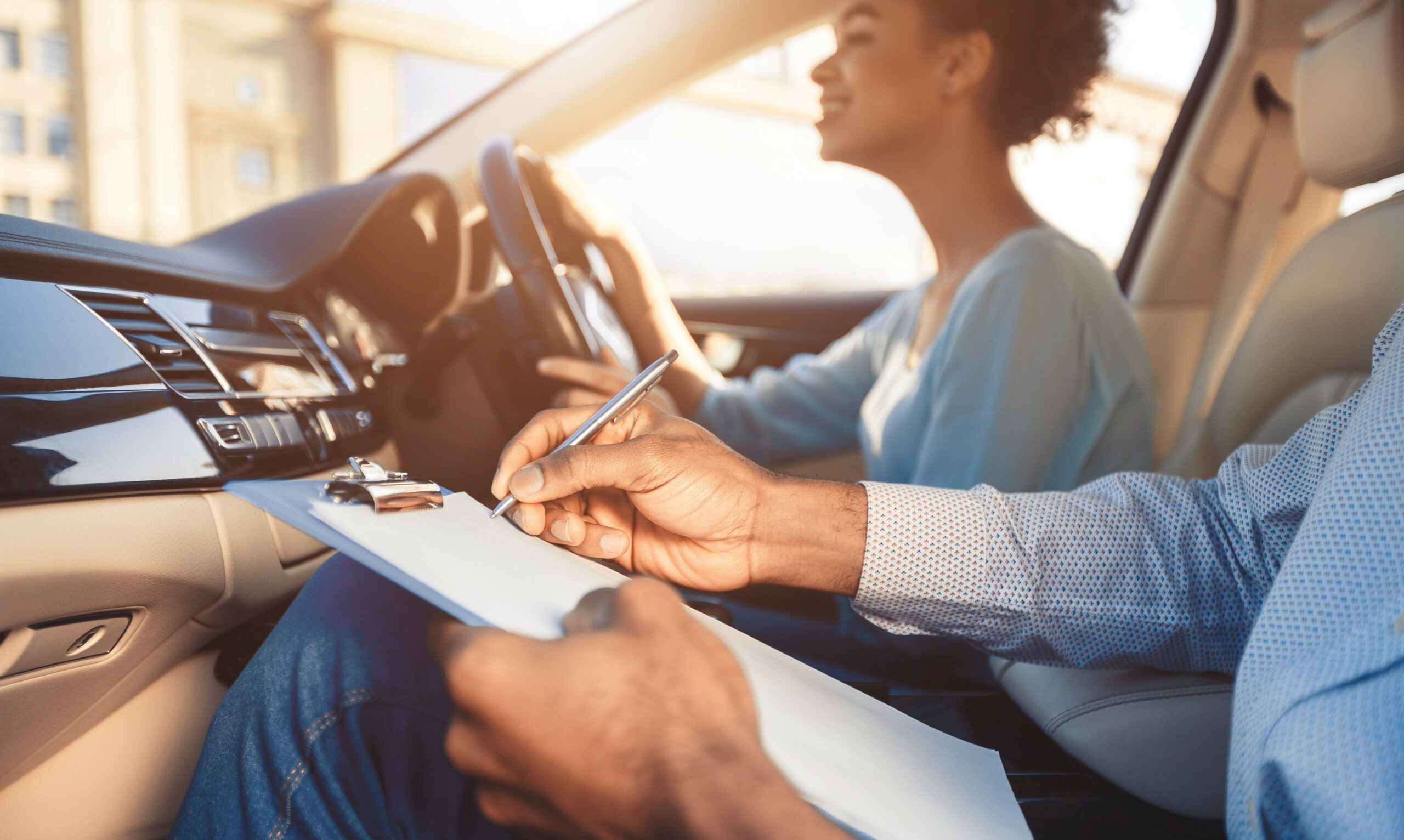 African American Girl Driving Sitting With Instructor In Car, Cropped