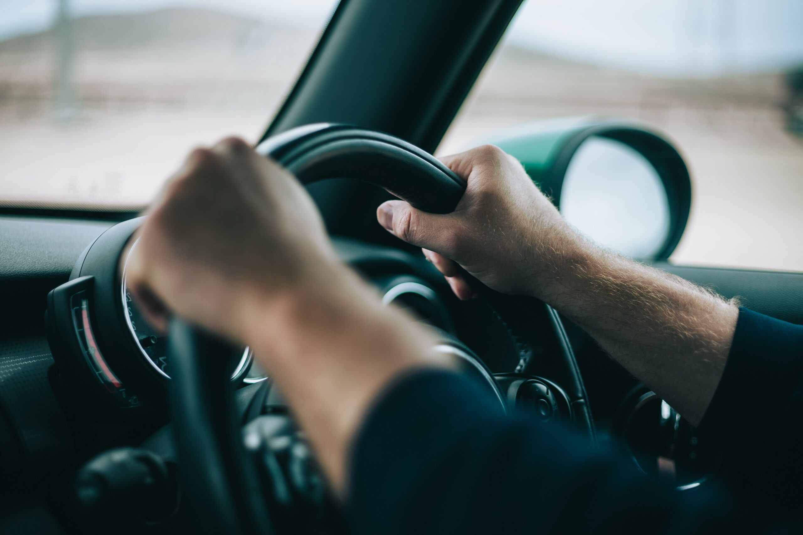 man-hands-on-the-steering-wheel-2022-07-01-06-01-29-utc